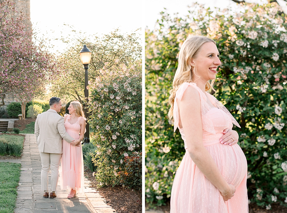 A pregnant woman wearing a pink dress embraces her husband during their Baker Park maternity photos in Frederick, Maryland.