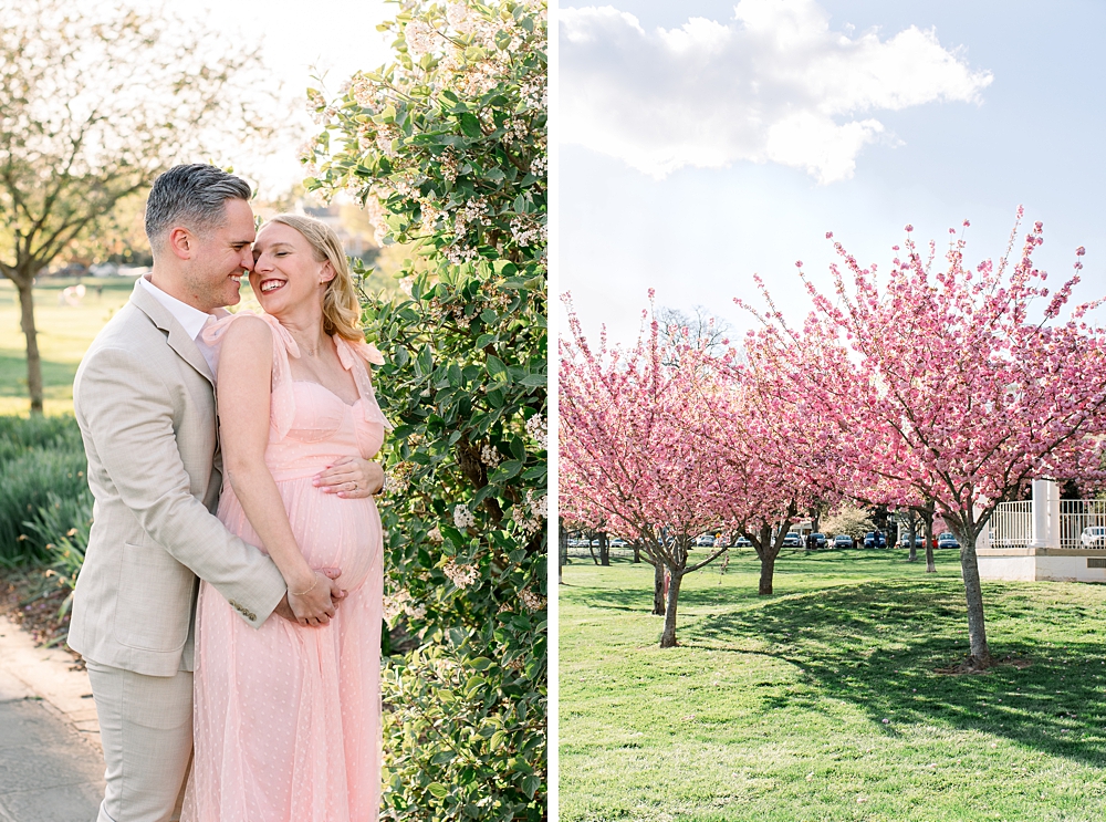 A pregnant woman wearing a pink dress embraces her husband during their Baker Park maternity photos in Frederick, Maryland.