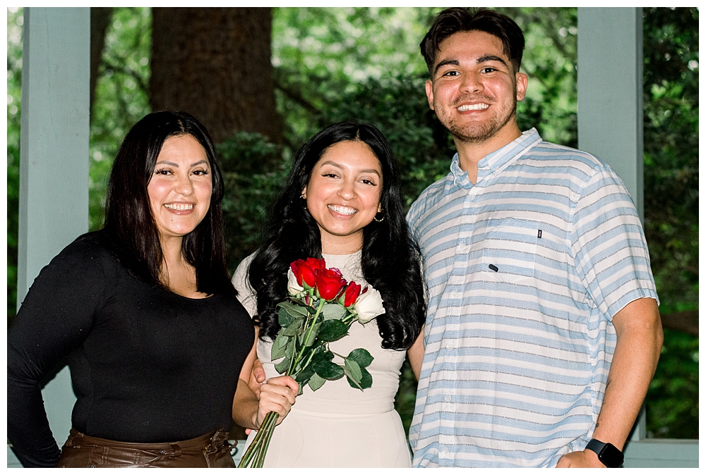 A recently engaged couple stands together after a surprise proposal at McCrillis Gardens in Bethesda, Maryland.