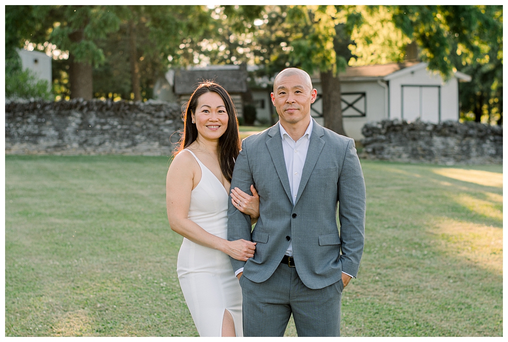A husband and wife stands together during their photo session at Rose Hill Manor in Frederick, Maryland.