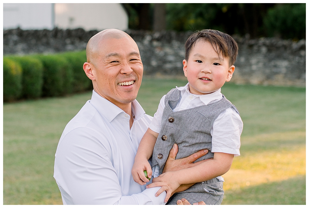 A father holds his son during their photo session at Rose Hill Manor in Frederick, Maryland.