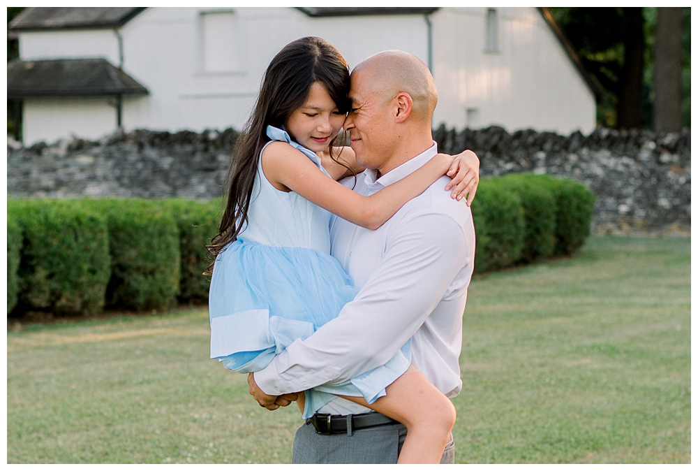 A father holds his daughter during their photo session at Rose Hill Manor in Frederick, Maryland.