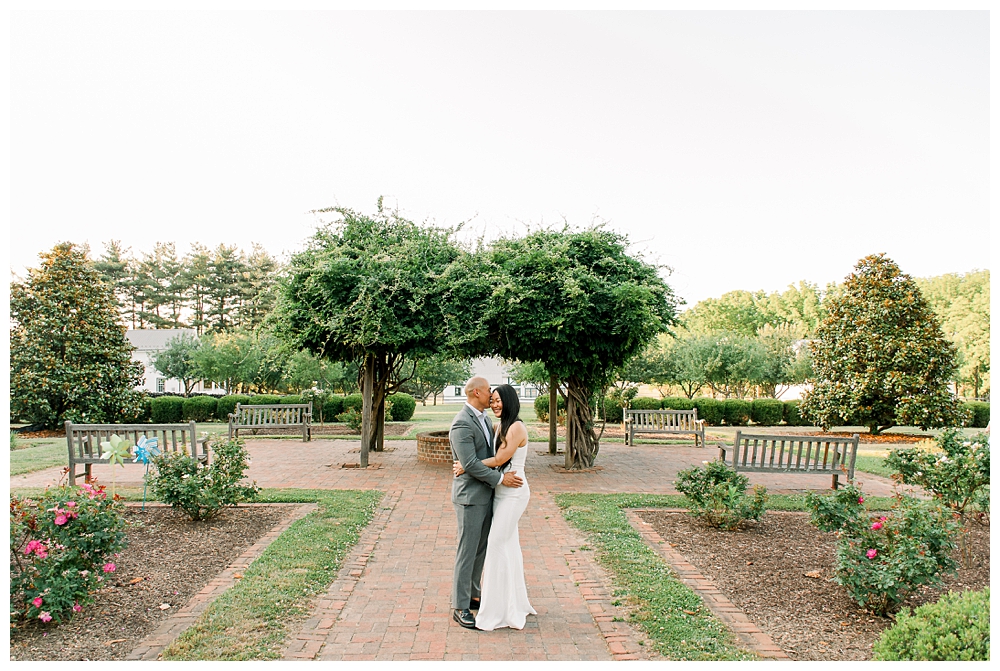 A husband embraces his wife during their photo session at Rose Hill Manor in Frederick, Maryland.